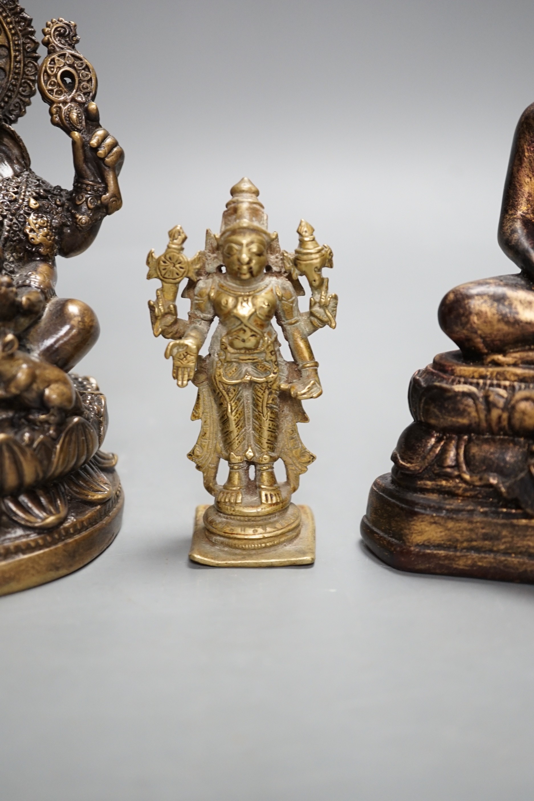 A Thai gilt resin model of Buddha, an Indian bronze model of Ganesh, a jadeite coloured carving of Guanyin and two other figures. Tallest 30cm